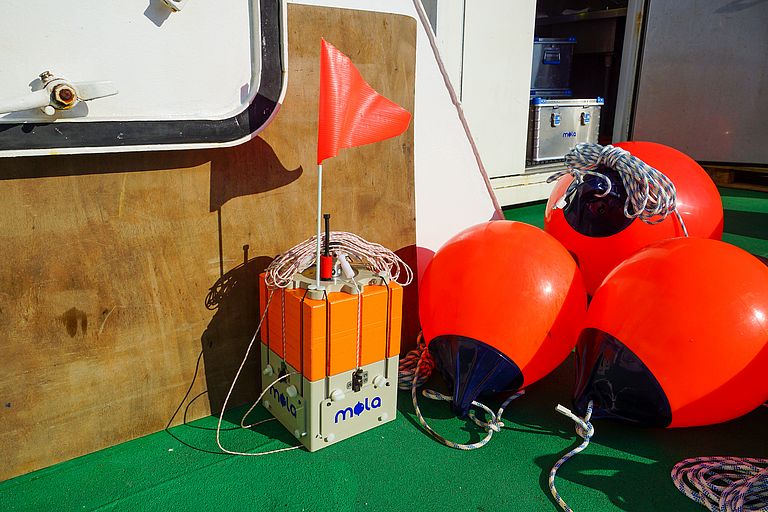 Bright orange buoys and an orange cube with "MOLA" written on it