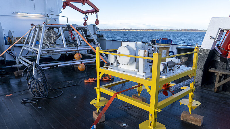 A yellow metal frame stands on board a research vesselprivate