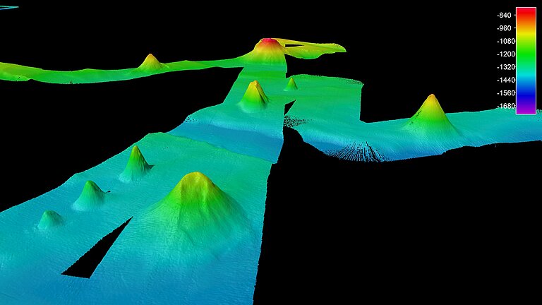 Mapping of underwater volcanoes. You can see a blue/green path with elevations - the volcanoes. The outside of the map is black.